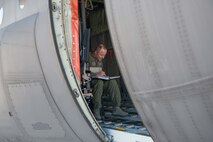 Master Sgt. Quentin Hall, a flight engineer from the 96th Airlift Squadron, calculates numbers for cargo weight and balance in preparation for a load to be put onto a C-130 at Exercise Saber Junction on April 10. (U.S. Air Force photo by Staff Sgt. Trevor Saylor)