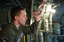 Senior Airman Alec Miller, a loadmaster from the 96th Airlift Squadron, watches as members of the Army's Joint Air Inspection team inspect the contents of a C-130 prior to takeoff at Aviano AB, Italy, in support of Exercise Saber Junction, on April 10. (U.S. Air Force photo by Staff Sgt. Trevor Saylor)