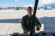 Senior Airman Alec Miller, a loadmaster from the 96th Airlift  Squadron, secures the end of a parachute to the ramp of a C-130 at Aviano AB, Italy, on April 10. (U.S. Air Force photo by Staff Sgt. Trevor Saylor)