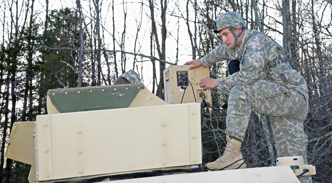 Pvt. Jesse Scott, a member of the Army Reserve’s 346th Psychological Operations Company (Airborne) out of Columbus, Ohio, works a vehicle mounted loud speaker during training at the Indiana National Guard’s Muscatatuck Urban Training Center on Wednesday, April 13. (Indiana National Guard photo by Master Sgt. Brad Staggs, Atterbury-Muscatatuck Public Affairs)