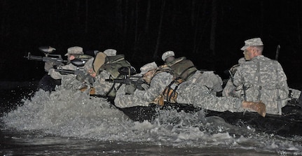 Members of the Army Reserve’s 346th Psychological Operations Company (Airborne) out of Columbus, Ohio, conduct night mission training on Brush Creek Reservoir at the Indiana National Guard’s Muscatatuck Urban Training Center on Wednesday, April 13. (photo by 1st Lt. Timothy Wilmetti, Chaplain Candidate, 15th Psychological Operations Battalion)