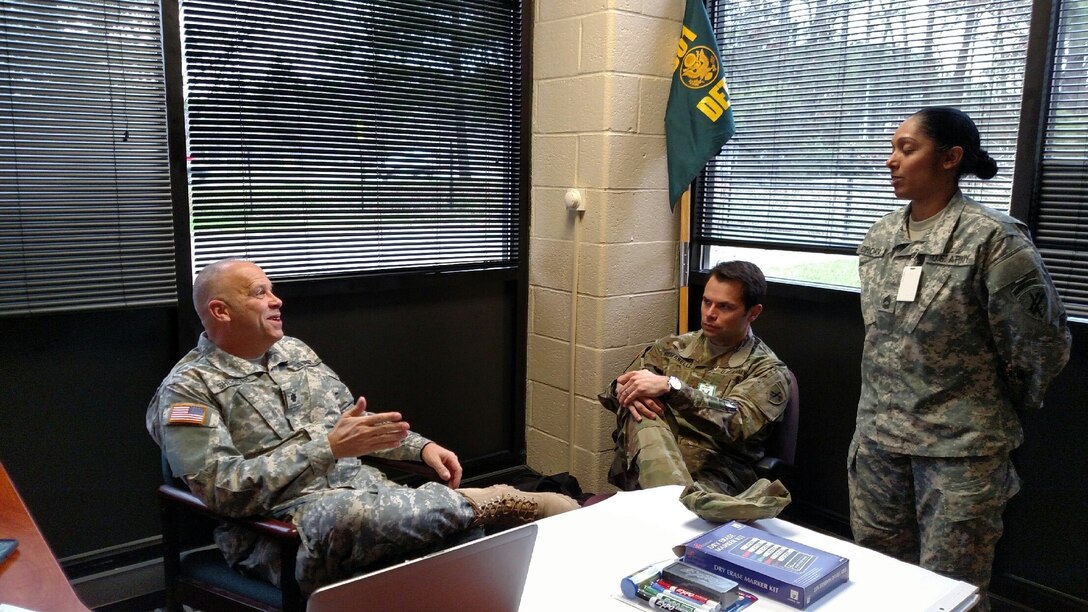 301st IO Battalion Commander Lt. Col. Patrick Sheridan discusses the validation exercise with Operations Officer Maj. Jason Romanello and Advisor Master Sgt. Jigna Chokshi at the Dekalb U.S. Army Reserve Center at Fort George G. Meade, Md., March 21, 2016. Members of the 301st IO Battalion conducted a validation exercise to earn certification on core information operations competencies. (U.S. Army photo by Capt. Jean Oliver/Released)