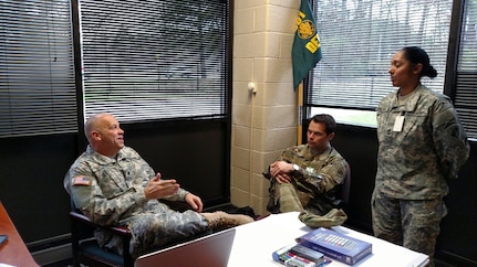 301st IO Battalion Commander Lt. Col. Patrick Sheridan discusses the validation exercise with Operations Officer Maj. Jason Romanello and Advisor Master Sgt. Jigna Chokshi at the Dekalb U.S. Army Reserve Center at Fort George G. Meade, Md., March 21, 2016. Members of the 301st IO Battalion conducted a validation exercise to earn certification on core information operations competencies. (U.S. Army photo by Capt. Jean Oliver/Released)