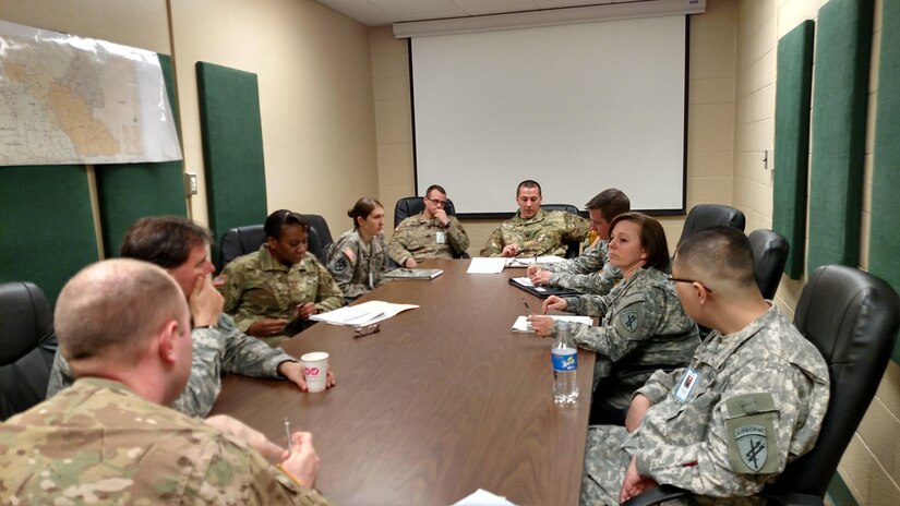 Soldiers of the 301st IO Battalion meet to discuss the final stages of the validation exercise at the Dekalb U.S. Army Reserve Center at Fort George G. Meade, Md., March 21, 2016. Members of the 301st IO Battalion conducted a validation exercise to earn certification on core information operations competencies. (U.S. Army photo by Capt. Jean Oliver/Released)