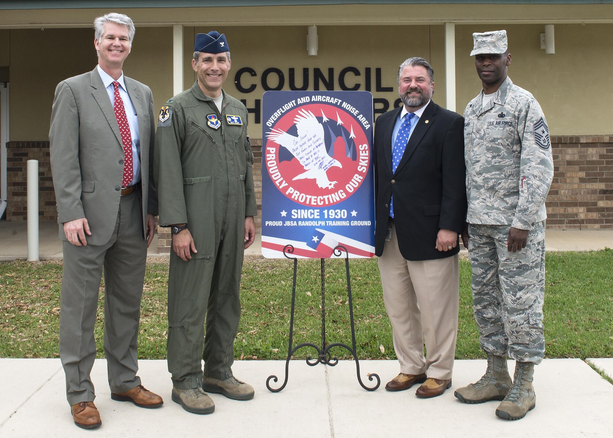From left to right: John Kessel, Schertz city manager, Col. Matthew Isler, 12th Flying Training Wing commander, Michael Carpenter, mayor of Schertz, and Chief Master Sgt. Troy Palmer, 12th FTW command chief, unveil the new city sign in front of the Schertz Council Chambers April 12, 2016. Joint Base San Antonio-Randolph and the city of Schertz are committed to keeping residents informed about aircraft training in the local area and the effects it may have on noise levels.