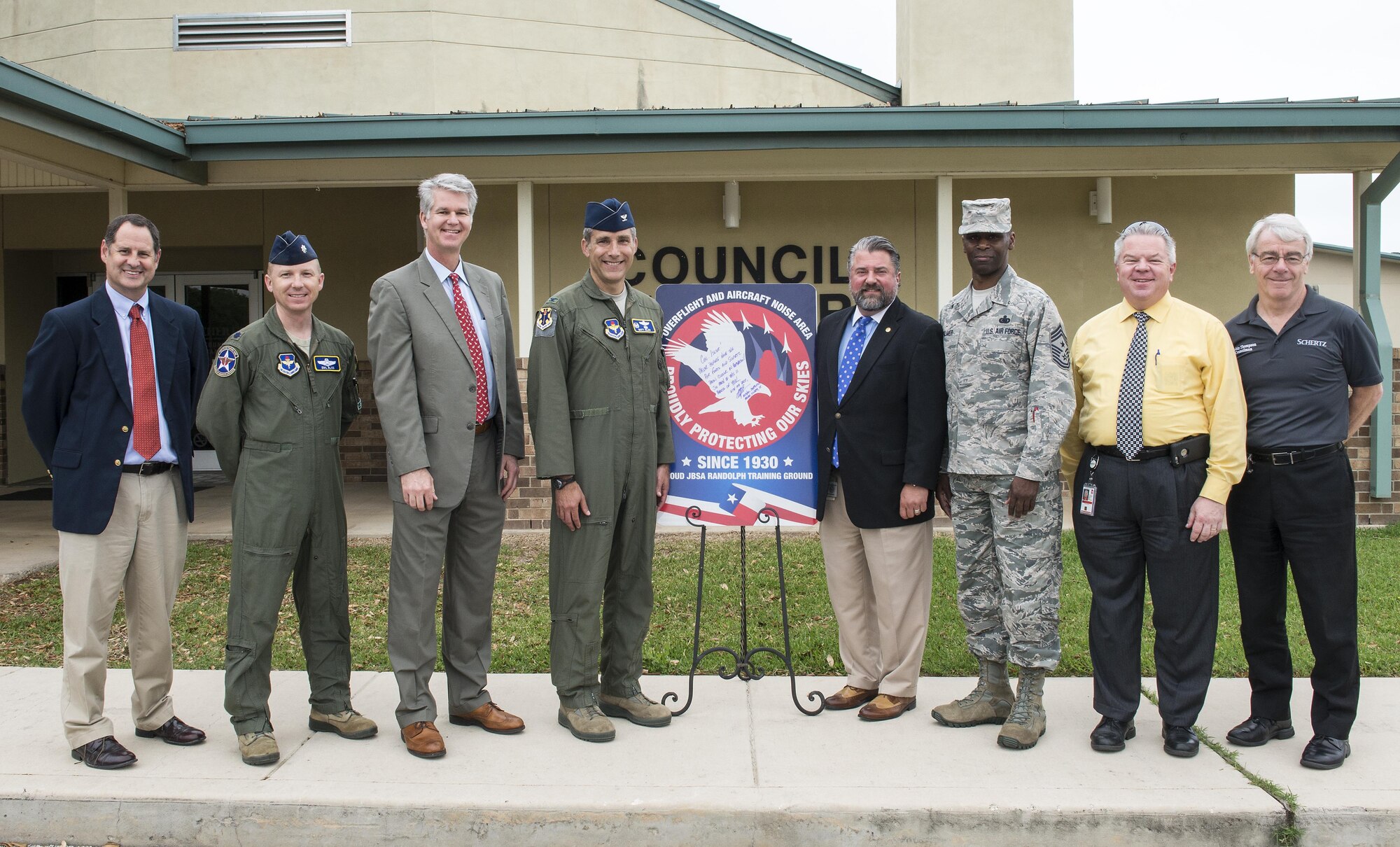 From left to right: Brian James, Schertz executive director of development, Lt. Col. Emil Bliss, 12th Flying Training Wing community initiatives director, John Kessel, Schertz city manager, Col. Matthew Isler, 12th FTW commander, Michael Carpenter, mayor of Schertz, Chief Master Sgt. Troy Palmer, 12th FTW command chief, Dudley Wait, executive director of operations, and Robin Thompson, Schertz place 5 council member, unveil the new city sign in front of the Schertz Council Chambers April 12, 2016. Joint Base San Antonio-Randolph and the city of Schertz are committed to keeping residents informed about aircraft training in the local area and the effects it may have on noise levels.