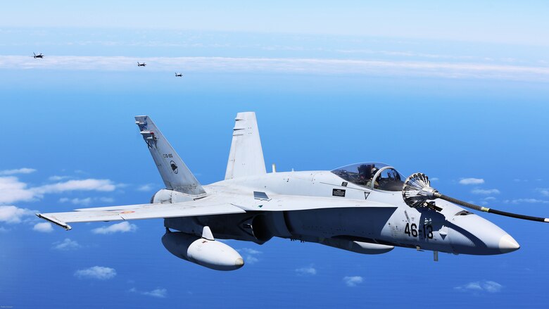 A Spanish Air Force F/A-18 Hornet with 462 Squadron refuels during an air-to-air refuel mission with a U.S. Marine Corps KC-130J with Marine Aerial Refueler Transport Squadron 252, Special-Purpose Marine Air-Ground Task Force-Crisis Response- Africa, Gran Canaria, Spain, Mar. 29, 2016. SPMAGTF-CR-AF Marines and Spanish airmen conducted air-to-air refueling missions in order to enhance crisis response readiness and help build relationships between the two militaries. 