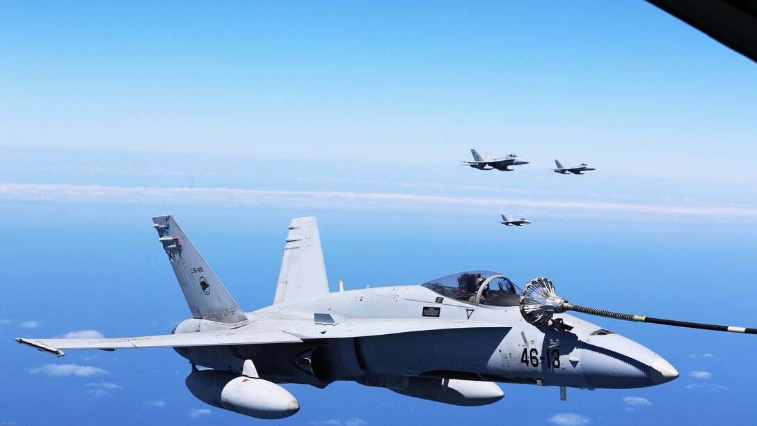 Spanish Air Force F/A-18 Hornets with 462 Squadron fly in formation during an air-to-air refuel mission with a U.S. Marine Corps KC-130J with Marine Aerial Refueler Transport Squadron 252, Special-Purpose Marine Air-Ground Task Force-Crisis Response- Africa, Gran Canaria, Spain, Mar. 29, 2016. SPMAGTF-CR-AF Marines and Spanish airmen conducted air-to-air refueling missions in order to enhance crisis response readiness and help build relationships between the two militaries.