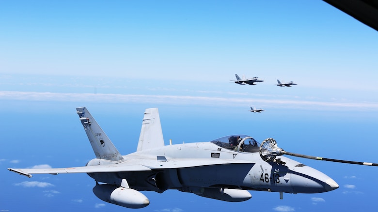 Spanish Air Force F/A-18 Hornets with 462 Squadron fly in formation during an air-to-air refuel mission with a U.S. Marine Corps KC-130J with Marine Aerial Refueler Transport Squadron 252, Special-Purpose Marine Air-Ground Task Force-Crisis Response- Africa, Gran Canaria, Spain, Mar. 29, 2016. SPMAGTF-CR-AF Marines and Spanish airmen conducted air-to-air refueling missions in order to enhance crisis response readiness and help build relationships between the two militaries.