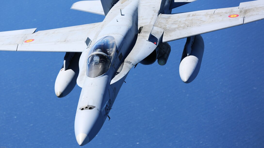 A Spanish Air Force F/A-18 Hornet with 462 Squadron breaks off after receiving fuel from a U.S. Marine Corps KC-130J with Marine Aerial Refueler Transport Squadron 252, Special-Purpose Marine Air-Ground Task Force-Crisis Response- Africa during an aerial refuel mission, Gran Canaria, Spain, Mar. 29, 2016. SPMAGTF-CR-AF Marines and Spanish airmen conducted air-to-air refueling missions in order to enhance crisis response readiness and help build relationships between the two militaries. 