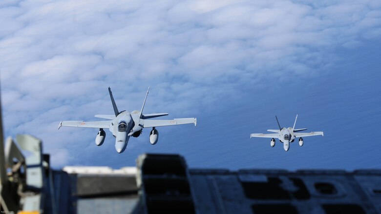 Spanish Air Force F/A-18 Hornets with 462 Squadron approach in formation during an air-to-air refuel mission with a U.S. Marine Corps KC-130J with Marine Aerial Refueler Transport Squadron 252, Special-Purpose Marine Air-Ground Task Force-Crisis Response- Africa, Gran Canaria, Spain, Mar. 29, 2016. SPMAGTF-CR-AF Marines and Spanish airmen conducted air-to-air refueling missions in order to enhance crisis response readiness and help build relationships between the two militaries. 