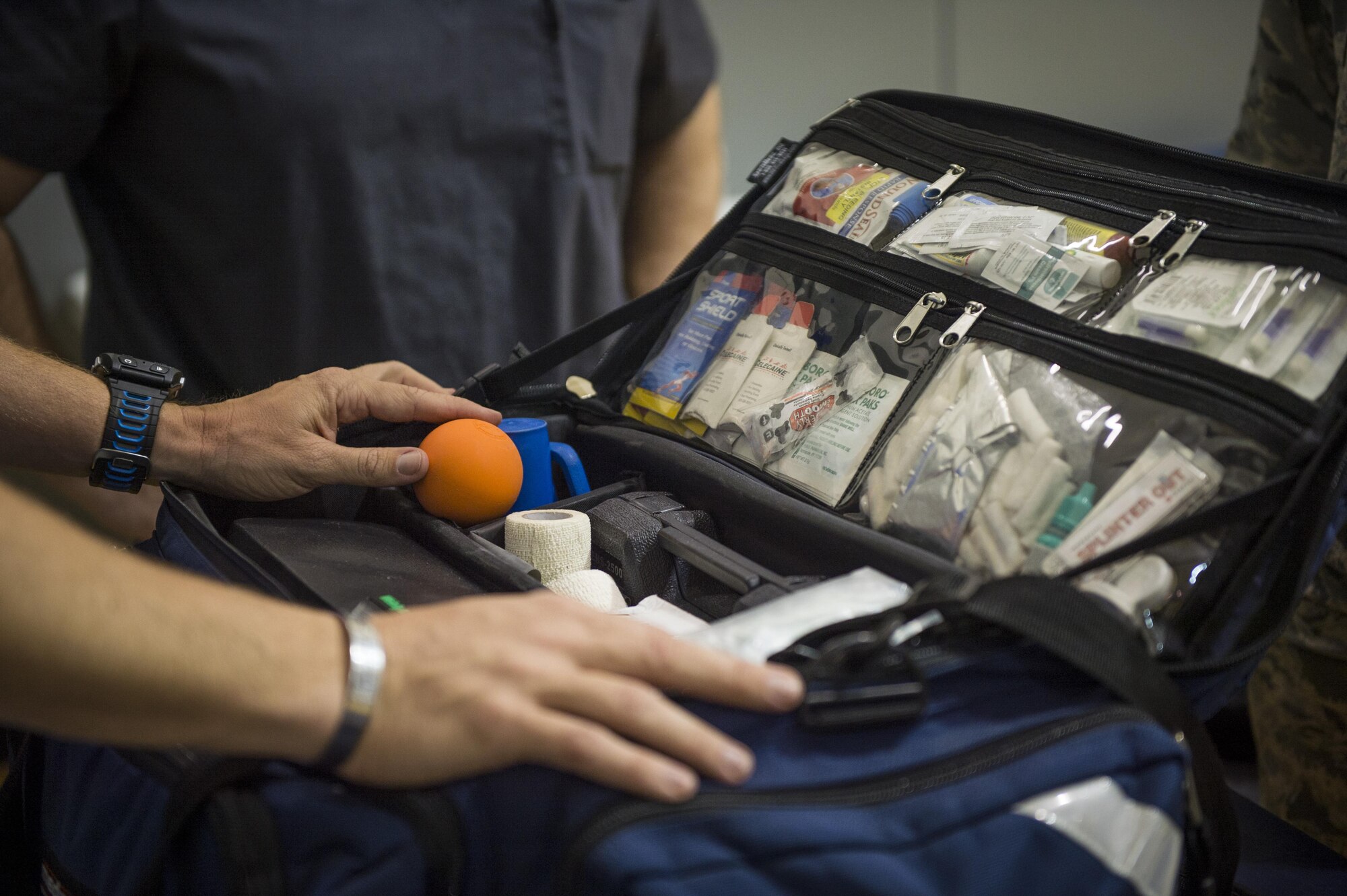 Maj. (Dr.) Sean Martin, the chief of sports medicine with Air Force Special Operations Command Office of the Surgeon General, prepares his medical bag before sitting volleyball practice during a Warrior Games training camp at Hurlburt Field, Fla., April 4, 2016. Martin and other medical technicians provide extra services to the athletes during the training camp to help them spend more time in the competition and off the sidelines. (U.S. Air Force photo by Staff Sgt. Marleah Miller)