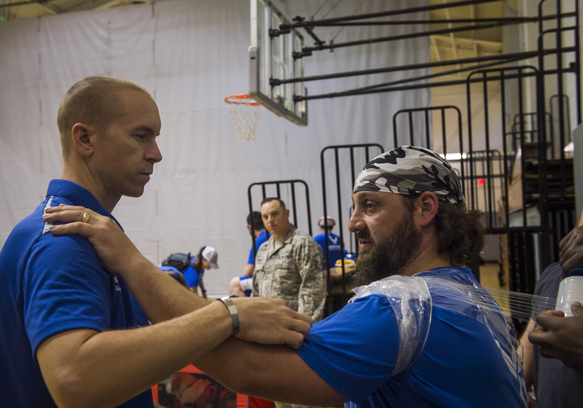 Maj. (Dr.) Sean Martin, the chief of sports medicine with Air Force Special Operations Command Office of the Surgeon General, helps retired Tech. Sgt. Cory Anderson, a wounded-warrior athlete, ice his shoulder after sitting volleyball practice at Hurlburt Field, Fla., April 4, 2016. Teams participate in seven sports to include archery, cycling, shooting, sitting-volleyball, swimming, track and field, and wheelchair basketball. (U.S. Air Force photo by Staff Sgt. Marleah Miller)