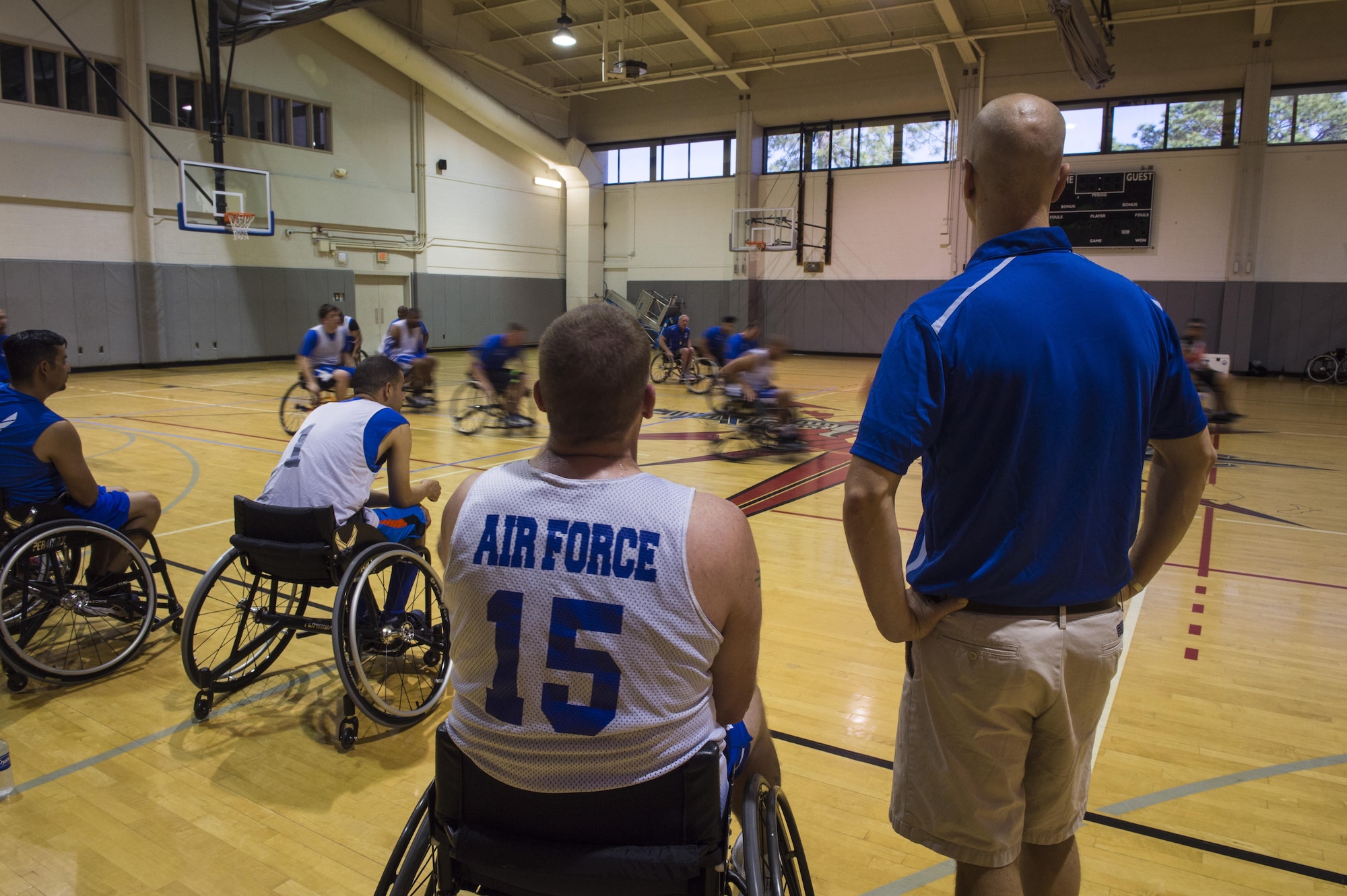 Maj. (Dr.) Sean Martin, right, the chief of sports medicine with Air Force Special Operations Command Office of the Surgeon General, talks to retired Tech. Sgt. Pat Young, left, a wounded-warrior athlete, during wheelchair basketball practice at Hurlburt Field, Fla., April 5, 2016. The Wounded Warrior Games, an annual event established in 2010, offers a competition for wounded, ill and injured service members, and veterans. (U.S. Air Force photo by Staff Sgt. Marleah Miller)