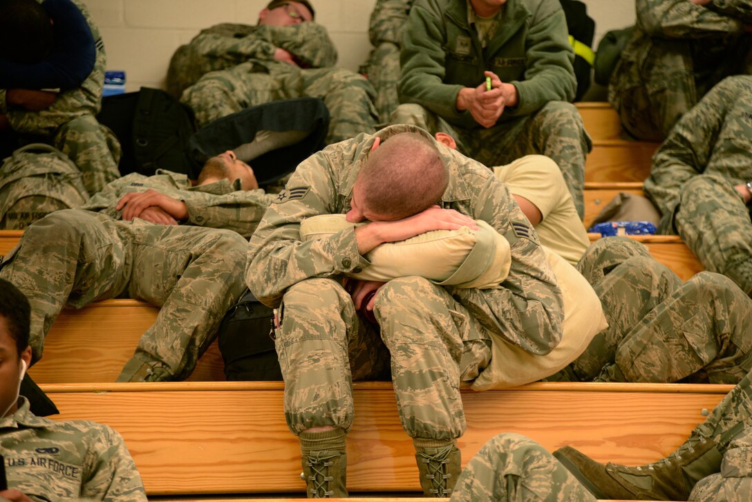 An Airman from the 4th Maintenance Group rests while waiting for a flight out of Seymour Johnson Air Force Base, North Carolina, April 10, 2016. Airmen deployed to Southwest Asia to support combatant commander requirements. (U.S. Air Force photo/Staff Sgt. Chuck Broadway)