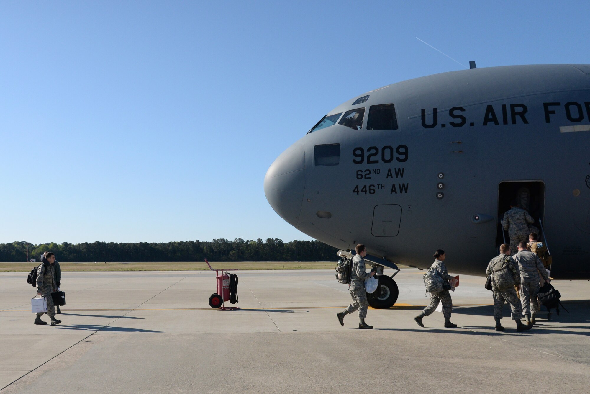 Airmen assigned to the 4th Fighter Wing board a C-17 Globemaster III aircraft, April 10, 2016, at Seymour Johnson Air Force Base, North Carolina. Multiple F-15E Strike Eagle aircraft and support personnel deployed to Southwest Asia to sustain on-going operations around the globe. (U.S. Air Force photo/Staff Sgt. Chuck Broadway)