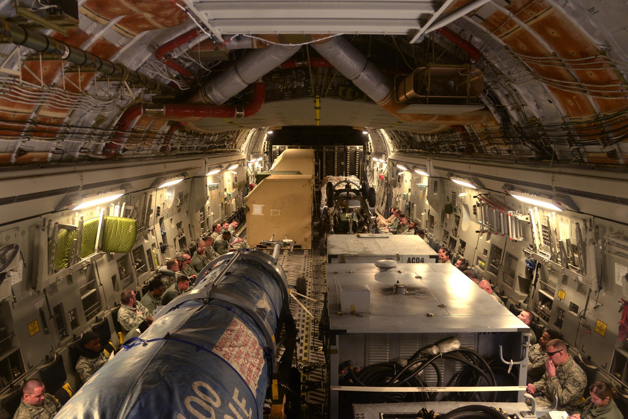 Airmen and cargo from the 4th Fighter Wing await departure aboard a C-17 Globemaster III aircraft from Joint-Base Lewis-McChord, Washington April 10, 2016, at Seymour Johnson Air Force Base, North Carolina. Seymour Johnson AFB deployed Airmen and aircraft to support contingency operations in Southwest Asia. (U.S. Air Force photo/Staff Sgt. Chuck Broadway)