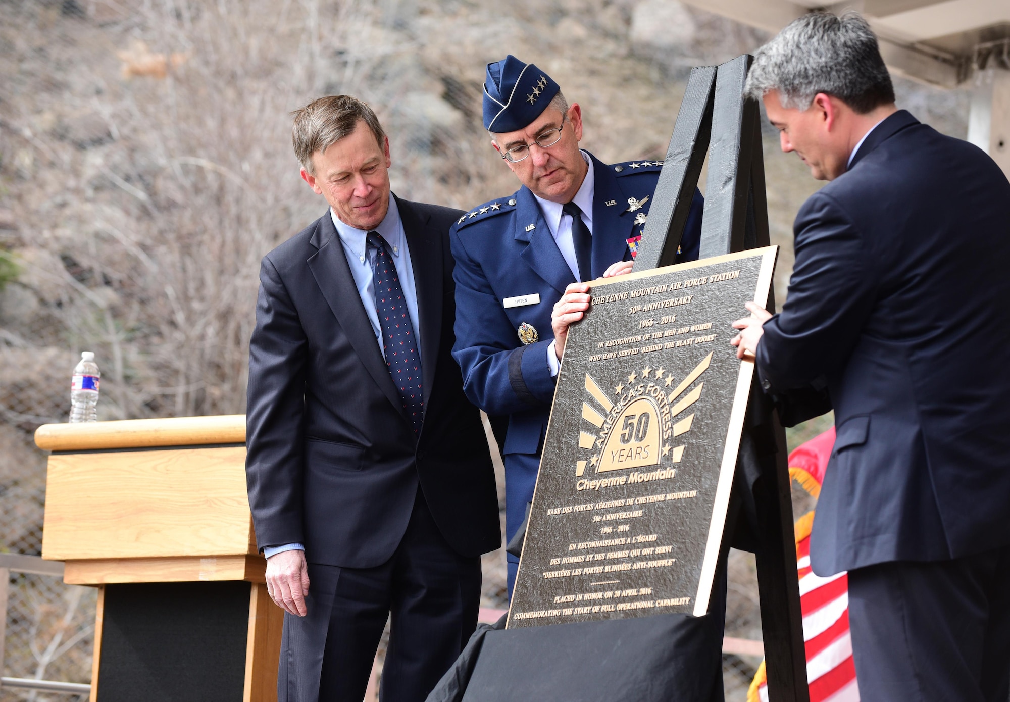 Colorado Gov. John Hickenlooper, Gen. John Hyten, the Air Force Space Command commander, and Colorado Sen. Cory Gardner unveil the 50th anniversary rededication ceremony plaque at Cheyenne Mountain Air Force Station, Colo., April 15, 2016. With the nickname "America's Fortress," Cheyenne Mountain AFS is situated beneath 2,000 feet of granite and consists of 15 buildings resting on more than 1,300 enormous steel springs. Cheyenne Mountain AFS is owned by the 21st Space Wing at Peterson Air Force Base, Colo., and operated by the 721st Mission Support Group. (U.S. Air Force photo/Staff Sgt. Amber Grimm) 