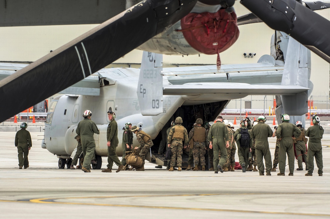 Marines prepare to board a MV-22 Osprey aircraft at Marine Corps Air Station Iwakuni, Japan, April 18, 2016. The Marines, assigned to Marine Medium Tiltrotor Squadron 265 Reinforced, picked up supplies from Japanese Camp Takayubaru and delivered them to Hakusui Sports Park in Kumamoto prefecture to support relief efforts following devastating earthquakes in the region. Marine Corps photo by Cpl. Nathan Wicks