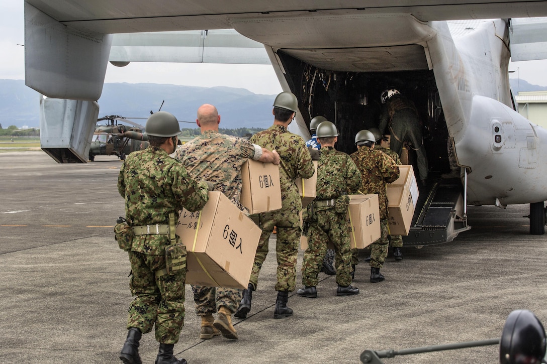 U.S. Marines and Japanese soldiers carry boxes of humanitarian aid into an MV-22 Osprey aircraft at Japanese Camp Takayubaru, Japan, April 18, 2016, to support relief efforts following devastating earthquakes near Kumamoto. Marine Corps photo by Cpl. Nathan Wicks