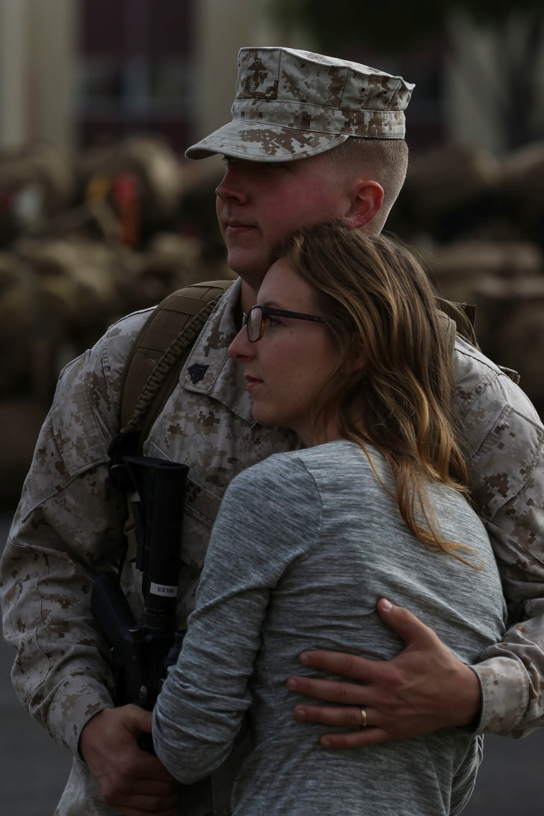 MARINE CORPS BASE CAMP PENDLETON, Calif. – Sgt. Ricki Miles, a counter-battery radar operator with the Special Purpose Marine Air-Ground Task Force - Crisis Response - Central Command 16.2, embraces his wife one last time before departing Camp Pendleton April 14, 2016. SPMAGTF-CR-CC is a rotational contingent of approximately 2,300 Marines and sailors sourced from units throughout I Marine Expeditionary Force. The unit serves as the Marine Corps’ land-based, expeditionary crisis and contingency force in U.S. Central Command. (U.S. Marine Corps photo by Cpl. Angel Serna/Released)