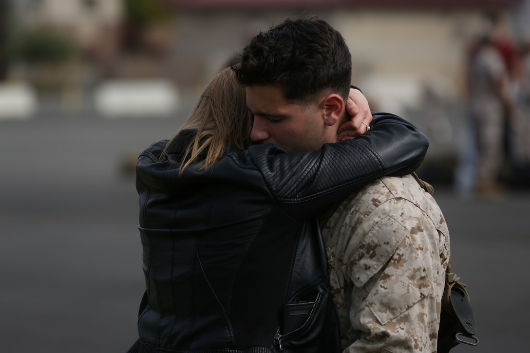 MARINE CORPS BASE CAMP PENDLETON, Calif. – Cpl. Mason Morgante, a scout observer with the Special Purpose Marine Air-Ground Task Force - Crisis Response - Central Command 16.2, hugs his girlfriend before departing Camp Pendleton April 14, 2016. SPMAGTF-CR-CC is a rotational contingent of approximately 2,300 Marines and sailors sourced from units throughout I Marine Expeditionary Force. The unit serves as the Marine Corps’ land-based, expeditionary crisis and contingency force in U.S. Central Command. (U.S. Marine Corps photo by Cpl. Angel Serna/Released)