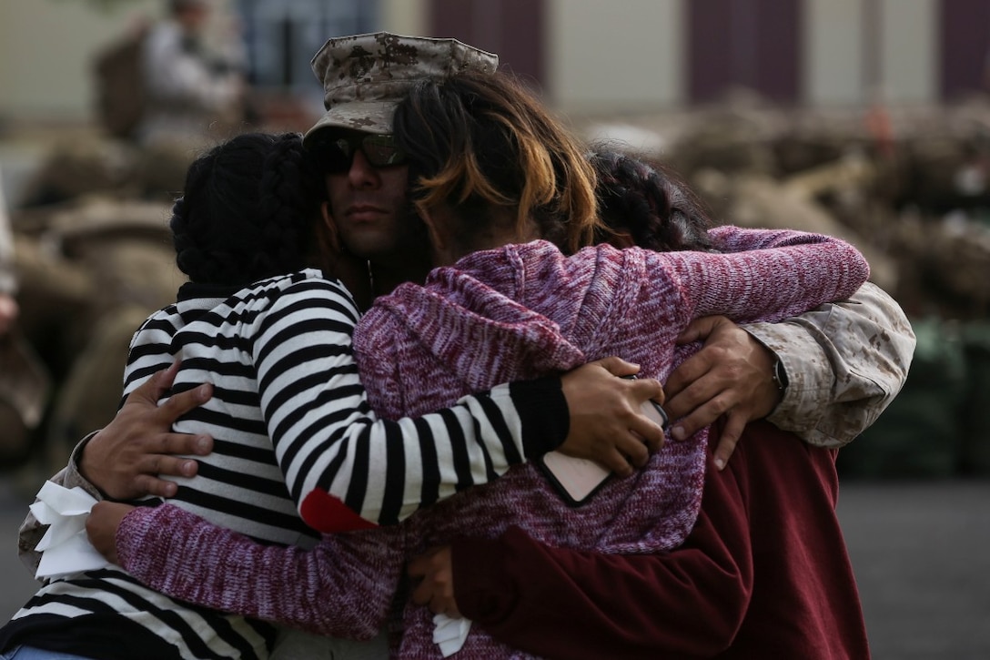 MARINE CORPS BASE CAMP PENDLETON, Calif. – Gunnery Sgt. Paul Quesada, an assistant operations chief with the Special Purpose Marine Air-Ground Task Force - Crisis Response - Central Command 16.2, embraces his wife and children before departing Camp Pendleton April 14, 2016. SPMAGTF-CR-CC is a rotational contingent of approximately 2,300 Marines and sailors sourced from units throughout I Marine Expeditionary Force. The unit serves as the Marine Corps’ land-based, expeditionary crisis and contingency force in U.S. Central Command. (U.S. Marine Corps photo by Cpl. Angel Serna/Released)