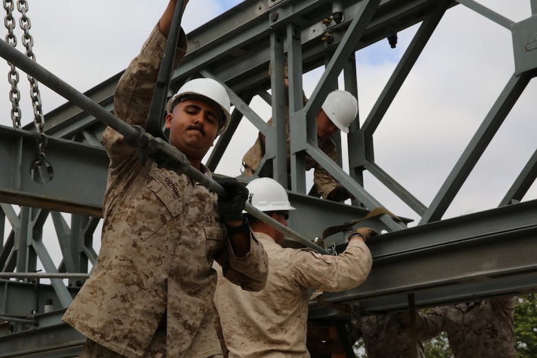 MARINE CORPS BASE CAMP PENDLETON, Calif. - Cpl. Jared Ordonez tightens the sway bracing of a bridge on Camp Talega at Camp Pendleton April 13, 2016. Ordonez is a combat engineer with 7th Engineer Support Battalion, I Marine Logistics Group, and is a Lima, Ohio native. The bridge is a 140-foot double-truss, single-story Bailey bridge. (U.S. Marine Corps photo by Lance Cpl. Shellie Hall/Released)