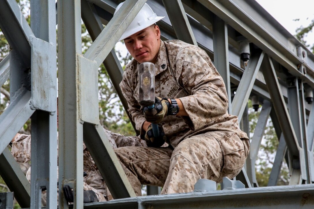 MARINE CORPS BASE CAMP PENDLETON, Calif. - Sgt. Chris Piette helps construct a bridge on Camp Talega at Camp Pendleton April 13, 2016. Piette is a combat engineer with 7th Engineer Support Battalion, I Marine Logistics Group, and is a De Pere, Wisconsin native. Bailey bridge was originally designed during World War II and was one of the most critical engineering components of that time. (U.S. Marine Corps photo by Lance Cpl. Shellie Hall/Released)