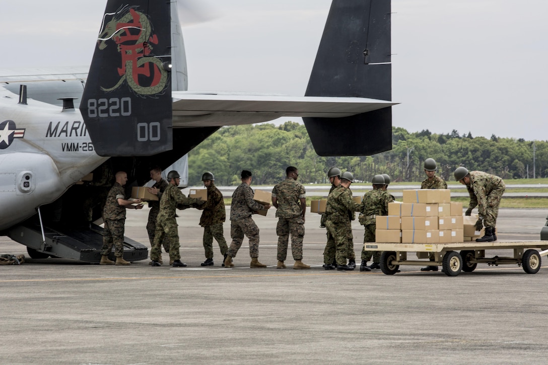 U.S. Marines and Japanese soldiers load boxes of humanitarian aid into an MV-22 Osprey aircraft at Japanese Camp Takayubaru, Japan, April 18, 2016, to support earthquake relief efforts near Kumamoto. Marine Corps photo by Cpl. Nathan Wicks