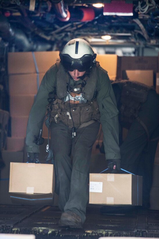 A U.S. service member unloads boxes of humanitarian aid from an MV-22 Osprey aircraft near Kumamoto, Japan, April 18, 2016. Marine Corps photo by Cpl. Nathan Wicks