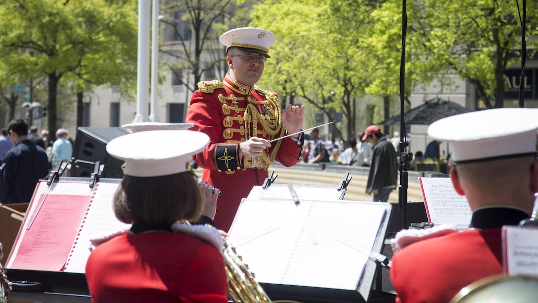 1st Lt. Ryan J. Nowlin conducts The President’s Own U.S. Marine Corps Band during the 25th annual Blessing of the Fleets ceremony at U.S. Navy Memorial in Washington, April 16. The Blessing of the Fleets ritual is intended to safeguard crews and ships from the danger of the seas through a blessing given by a clergyman at the water’s edge. During the ceremony, sailors from the U.S. Navy’s Ceremonial Guard and Marines from the U.S. Marine Barracks, Washington, DC, proceeded across the outdoor plaza’s “Granite Sea” and poured water from the Seven Seas and Great Lakes into the surrounding fountains, “charging” them to life and welcoming the spring season. 