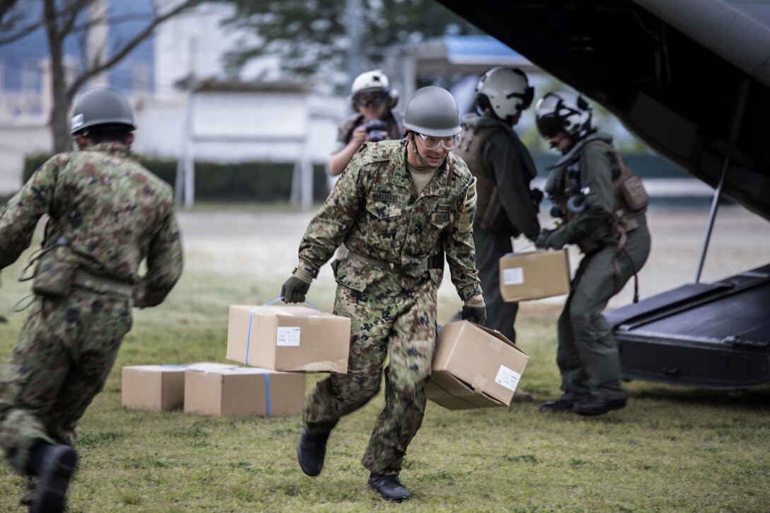 Japanese soldiers unload boxes of humanitarian aid from a Marine Corps MV-22 Osprey aircraft near Kumamoto, Japan, April 18, 2016. Marine Corps photo by Cpl. Nathan Wicks