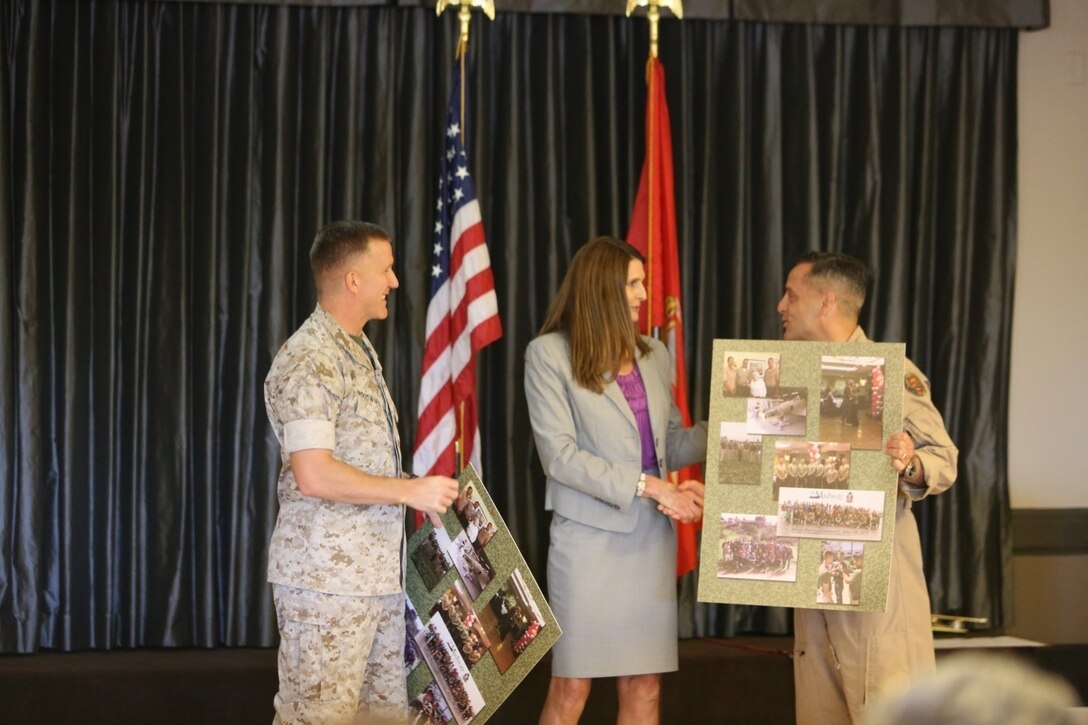 Col. Jason Woodworth, left, commanding officer of Marine Corps Air Station Miramar, and Maj. Gen. Michael Rocco, commanding general of the 3rd Marine Aircraft Wing, accept posters at the volunteer appreciation ceremony aboard MCAS Miramar, Calif., April 14. The ceremony is held each year during National Volunteer Appreciation Week to acknowledge the contributions volunteers make to the MCAS Miramar and San Diego communities. (U.S Marine Corps photo by Pfc. Liah Kitchen/ Released)