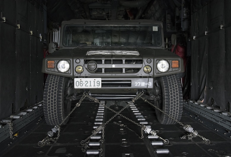 A Japan Ground Self-Defense Force vehicle sits strapped down in a U.S. Air Force C-130 Hercules at Chitose, Hokkaido, Japan, April 18, 2016. Two C-130s from Yokota Air Base, Japan picked up four vehicles and eight JGSDF members and flew them to the island of Kyushu to assist in disaster relief operations following a series of earthquakes that struck Japan. (U.S. Air Force photo by Staff Sgt. Michael Washburn/Released)
