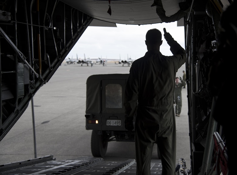 U.S. Air Force Master Sgt. Ryan Atkinson, 36th Airlift Squadron loadmaster, gives a thumbs up to the driver of a Japan Ground Self-Defense Force vehicle as it is loaded on a C-130 Hercules at Chitose, Hokkaido, Japan, April 18, 2016. On April 14 and again on April 16, Japan was struck by devastating earthquakes. The Government of Japan requested the assistance of U.S. Forces Japan, and the 374th Airlift Wing is supporting by transporting vehicles and personnel from Hokkaido to Kumamoto prefecture. (U.S. Air Force photo by Staff Sgt. Michael Washburn/Released)