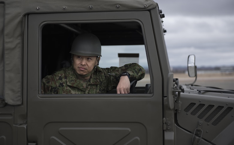 A member of the Japan Ground Self-Defense Force sits in a vehicle awaiting instructions at Chitose, Hokkaido, Japan, April 18, 2016. Members of the 374th Airlift Wing traveled to Hokkaido and airlifted four vehicles and eight JGSDF personnel to Kumamoto Prefecture. (U.S. Air Force photo by Staff Sgt. Michael Washburn/Released)
