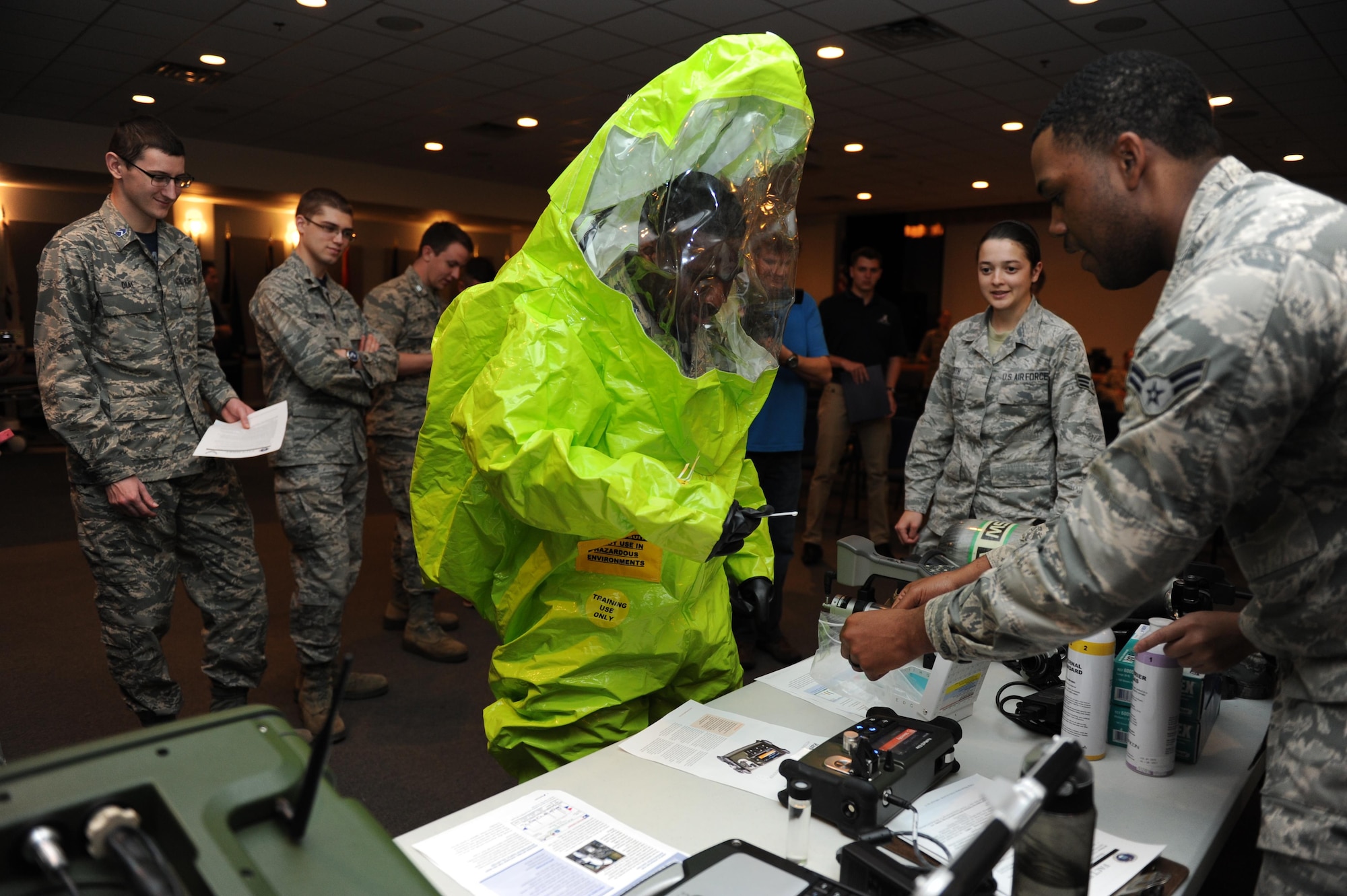 Airman 1st Class Devin Harris, 81st Aerospace Medicine Squadron bioenvironmental technician, helps De’Terris Fox, University of Mississippi Air Force ROTC Cadet, test his finger dexterity while wearing a hazardous material suit at the Keesler Medical Center during Pathways to Blue April 15, 2016, Keesler Air Force Base, Miss. Pathways to Blue, a diversity outreach event hosted by 2nd Air Force, the 81st Training Wing and the 403rd Wing, included more than 180 cadets from Air Force ROTC detachments from various colleges and universities. Cadets received hands-on briefings on technical and flying operations and an orientation flight in support of the Air Force's Diversity Strategic Roadmap program. (U.S. Air Force photo by Kemberly Groue)