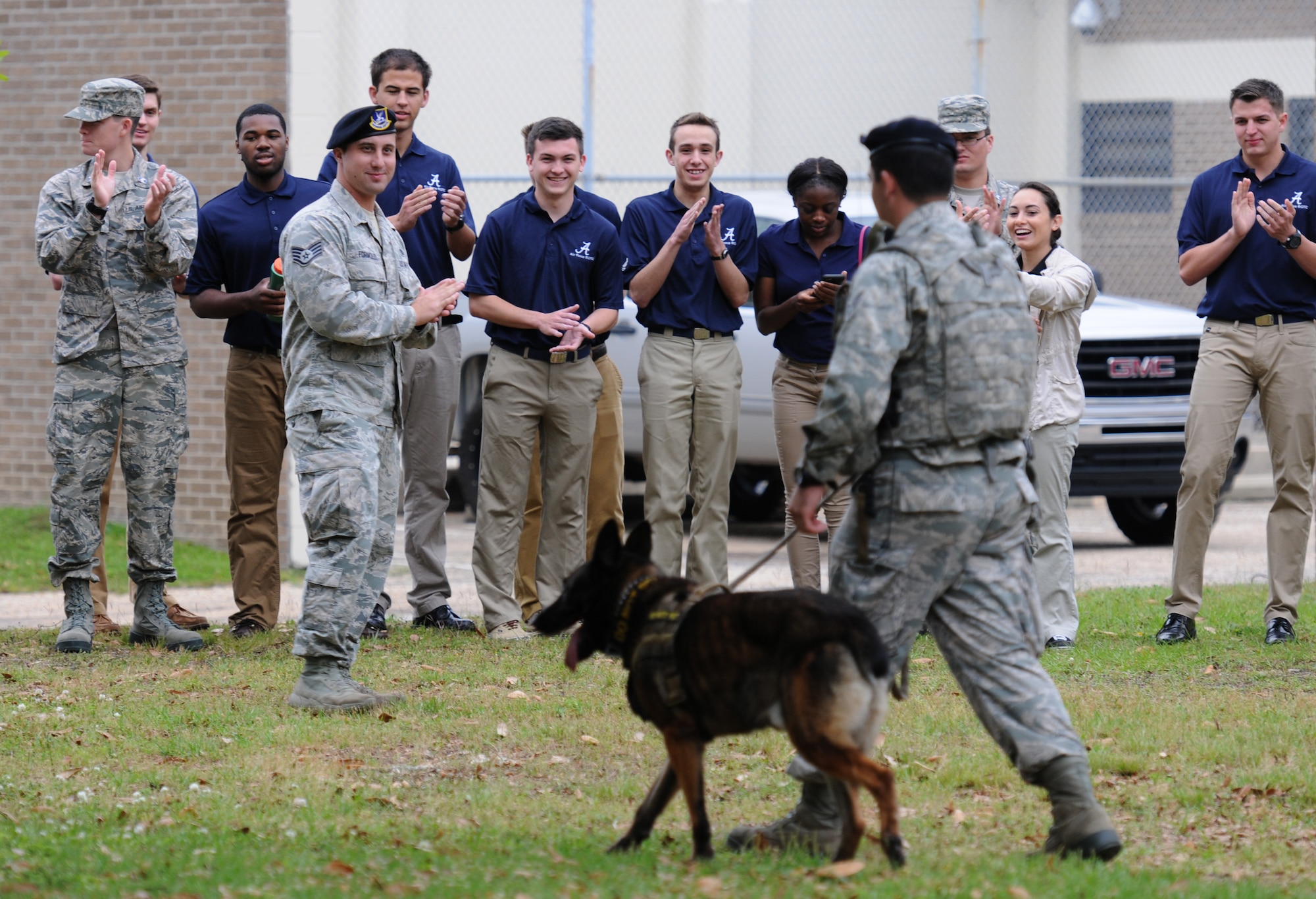 Air Force ROTC cadets applaud after a military working dog demonstration by Senior Airman Matthew Ratchford, 81st Security Forces Squadron military working dog handler and his dog Toki, during Pathways to Blue April 15, 2016, Keesler Air Force Base, Miss. Pathways to Blue, a diversity outreach event hosted by 2nd Air Force, the 81st Training Wing and the 403rd Wing, included more than 180 cadets from Air Force ROTC detachments from various colleges and universities. Cadets received hands-on briefings on technical and flying operations and an orientation flight in support of the Air Force's Diversity Strategic Roadmap program.  (U.S. Air Force photo by Kemberly Groue)

