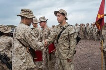 U.S. Marines with Battery B, Battalion Landing Team 2nd Battalion, 1st Marine Regiment, 13th Marine Expeditionary Unit make time to award the Marines who've earned it in Djibouti, Africa, Apr. 11, 2016.(U.S. Marine Corps photo by Cpl. Alvin Pujols/RELEASED)