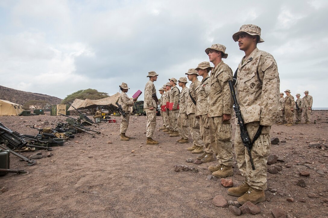 U.S. Marines with Battery B, Battalion Landing Team 2nd Battalion, 1st Marine Regiment, 13th Marine Expeditionary Unit make time to award the Marines who've earned it in Djibouti, Africa, Apr. 11, 2016.(U.S. Marine Corps photo by Cpl. Alvin Pujols/RELEASED)