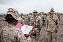 U.S. Marines with Battery B, Battalion Landing Team 2nd Battalion, 1st Marine Regiment, 13th Marine Expeditionary Unit make time to award the Marines who've earned it in Djibouti, Africa, Apr. 11, 2016.(U.S. Marine Corps photo by Cpl. Alvin Pujols/RELEASED)
