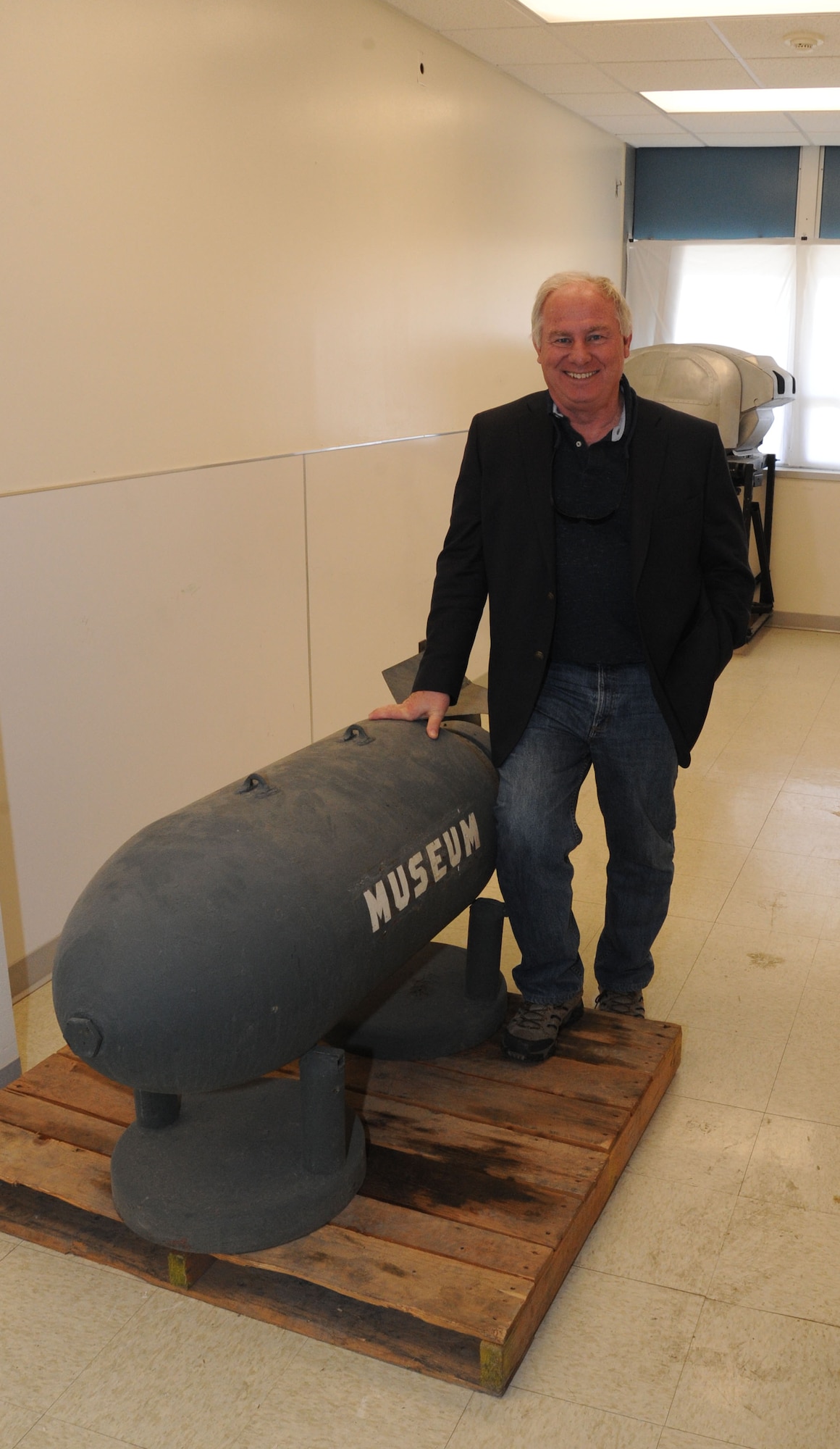 Tobby Hatley, Honor Point Military and Aerospace Museum project manager, stands next to Ed Kaluza’s time capsule bomb in the old Geiger Field base dining facility on the grounds of Spokane International Airport in Spokane, Wash., April 6, 2016. The time capsule was filled in 1966, not to be opened again until 2066. (U.S. Air Force photo/Senior Airman Sam Fogleman)