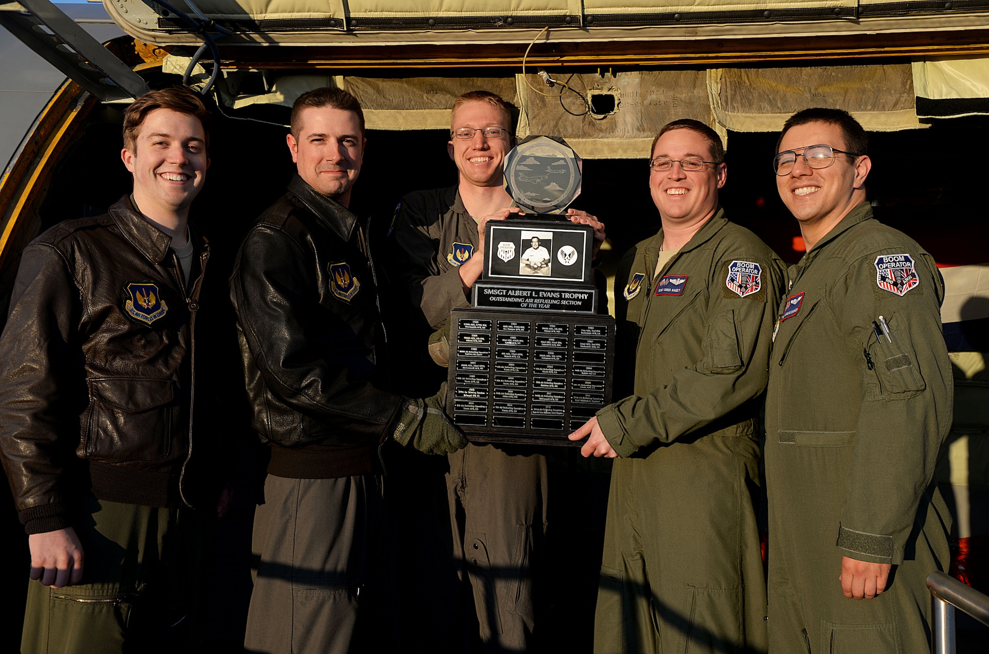 U.S. Air Force Airmen from the 351st Air Refueling Squadron unload the Senior Master Sgt. Albert L. Evans Outstanding Air Refueling Section of the Year Award from a KC-135 Stratotanker April 18, 2016, on RAF Mildenhall, England. Every year this award recognizes the best in-flight boom operator section within the U.S. Air Force. Airmen of the 351st ARS flew more than 1,500 missions in 2015. (U.S. Air Force photo by Airman 1st Class Tenley Long/Released)
