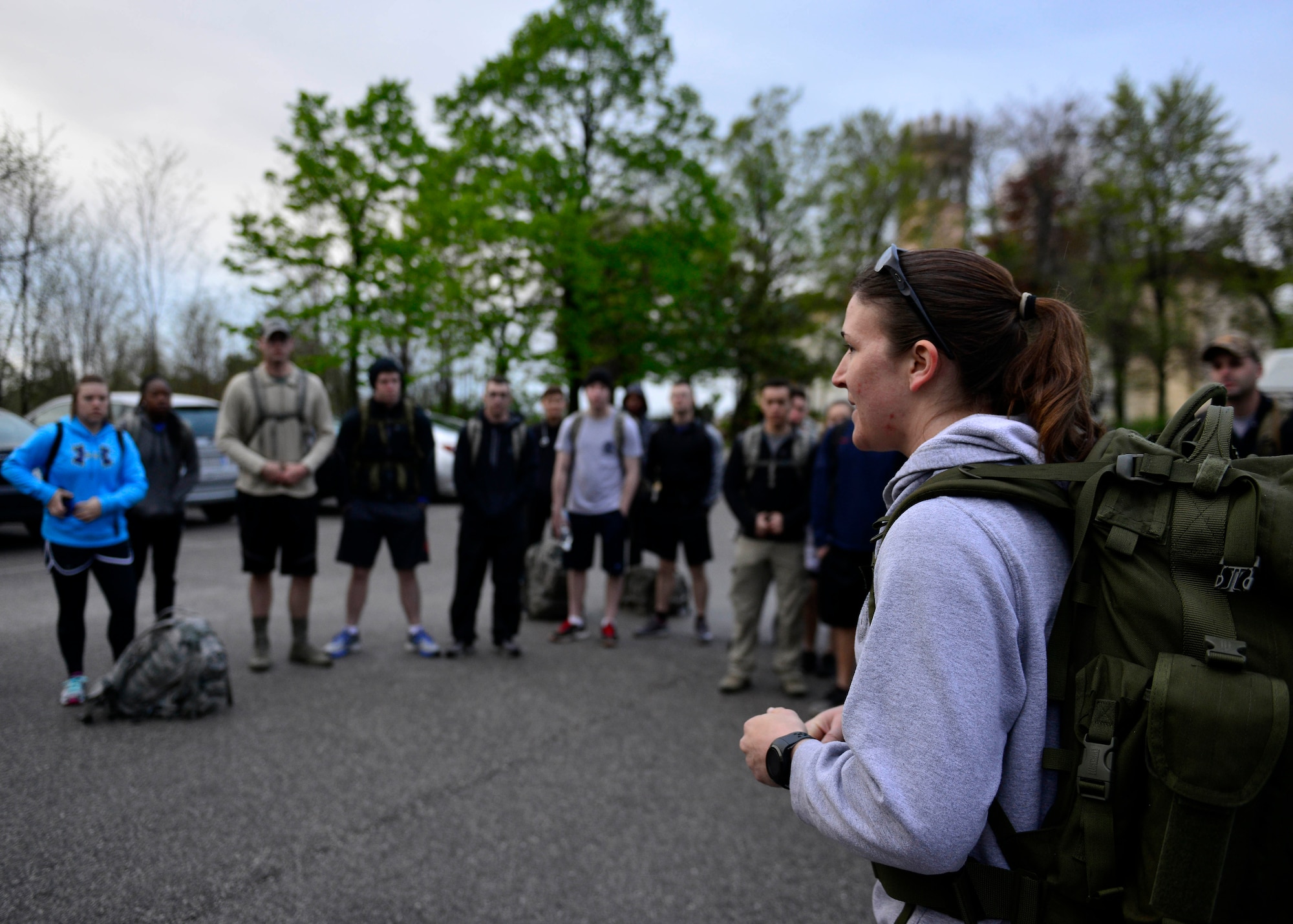 Special Agent Lyndsey Banks, U.S. Air Force Office of Special Investigations, speaks to Team Aviano members at a ruck march, April 14, 2016, in Costa di Aviano, Italy. The ruck march was organized to remember four OSI and two Security Forces members who died in a December, 2015, attack in Afghanistan. (U.S. photo by Airman 1st Class Cary Smith/Released)