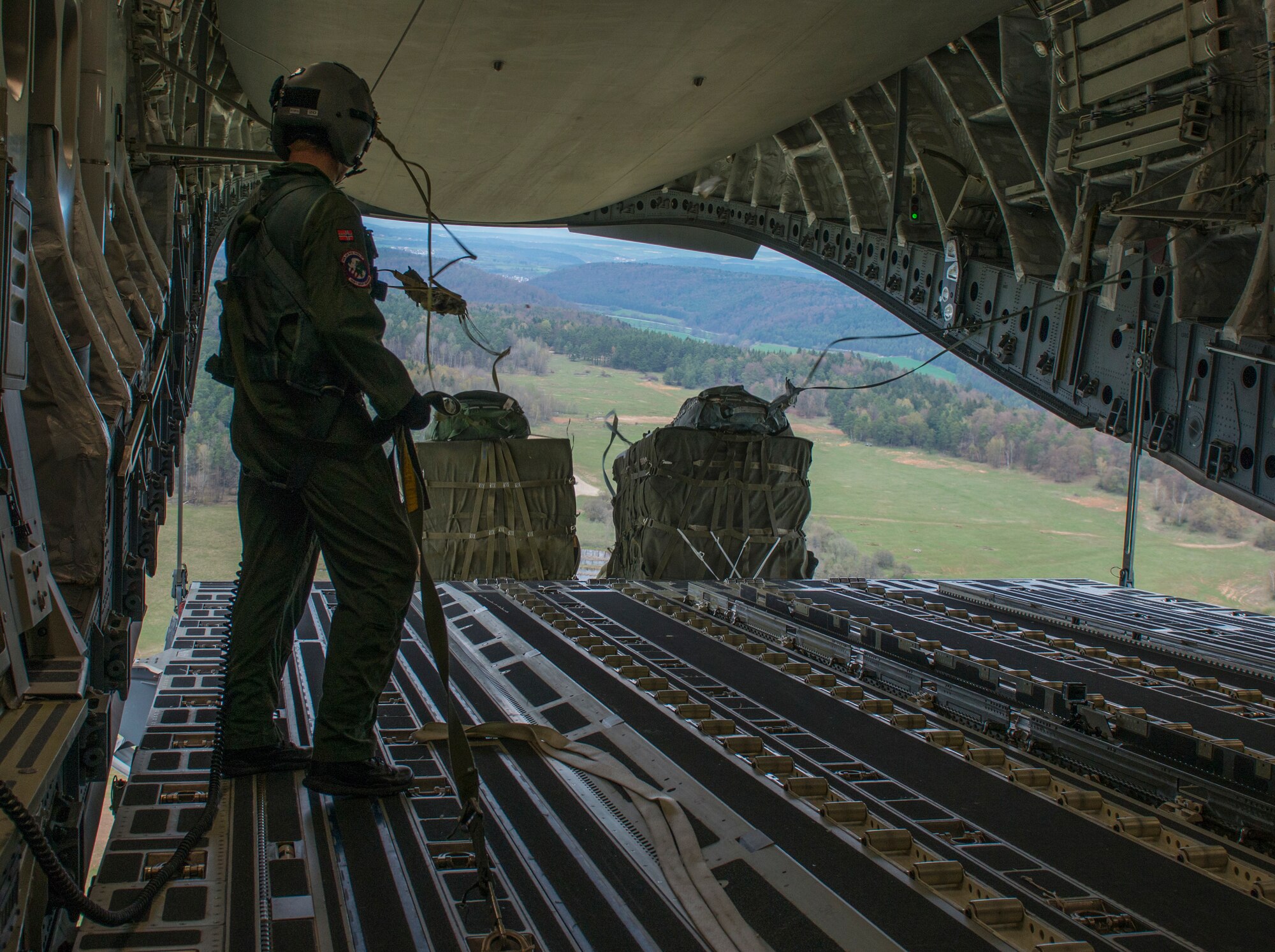 Royal Norwegian air force 2nd Lt. Ulrick Naustuik, Heavy Airlift Squadron loadmaster, participates in Saber Junction 16, April 13, 2016, over Hohenfels, Germany. The exercise involved the 173rd Airborne Brigade and 16 allied and European nations conducting land operations in a joint, combined environment and to promote interoperability with participating nations. (U.S. Air Force photo by Senior Airman Krystal Ardrey/Released)