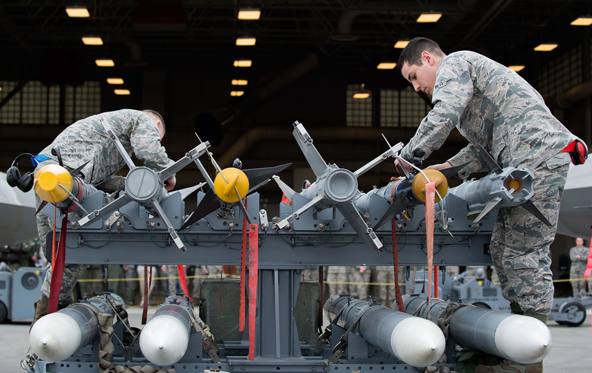 Crew members for the 525th and 90th Aircraft Munition Units conduct a munition preparation during the first quarter load crew competition at Joint Base Elmendorf-Richardson, Alaska, April 15, 2016. (U.S. Air Force photo by Staff Sgt. Sheila deVera)