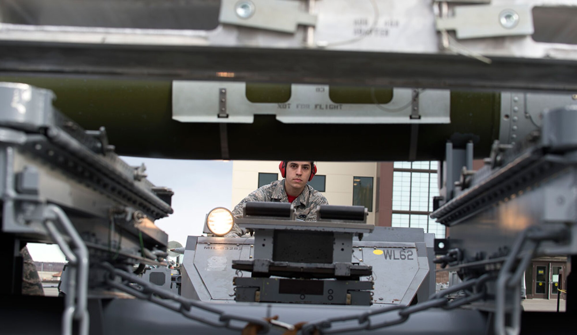 Airman 1st Class Kendal Henthorn, 90th Aircraft Maintenance Unit load crew member, operates a positioning jammer to pick up a GBU-32 during the first quarter load crew competition at Joint Base Elmendorf-Richardson, Alaska, April 15, 2016. The 90th AMU 'Pair-o-Dice' won the load crew competition. (U.S. Air Force photo by Staff Sgt. Sheila deVera)