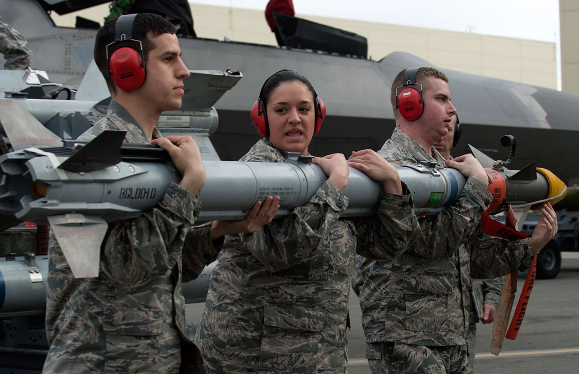 Airmen from the 90th Aircraft Maintenance Unit transport a munition during the first quarter load crew competition at Joint Base Elmendorf-Richardson, Alaska, April 15, 2016. Each member used a three-Airman team to properly load a munition onto an aircraft. (U.S. Air Force photo by Staff Sgt. Sheila deVera)