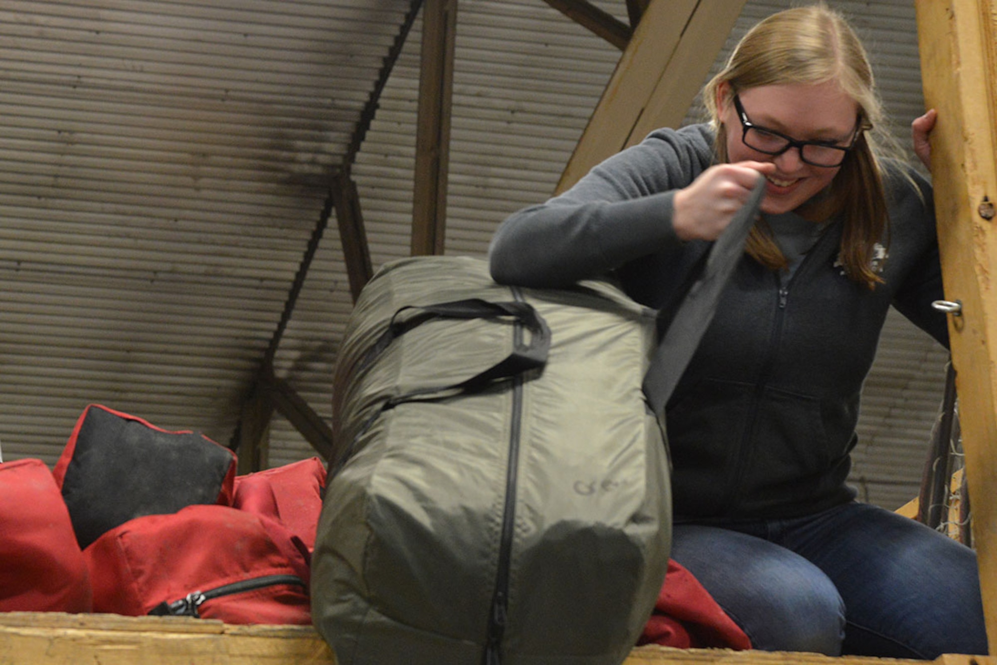 Olivia Walker, Outdoor Recreation Center recreation aide, brings out the camping equipment in preparation for the summer rental season at the Joint Base Elmendorf-Richardson ORC, April 12, 2016. The JBER-Richardson ORC is currently accepting reservations for their inventory and is scheduled to open April 25. (U.S. Air Force Photo by Airman 1st Class Javier Alvarez)